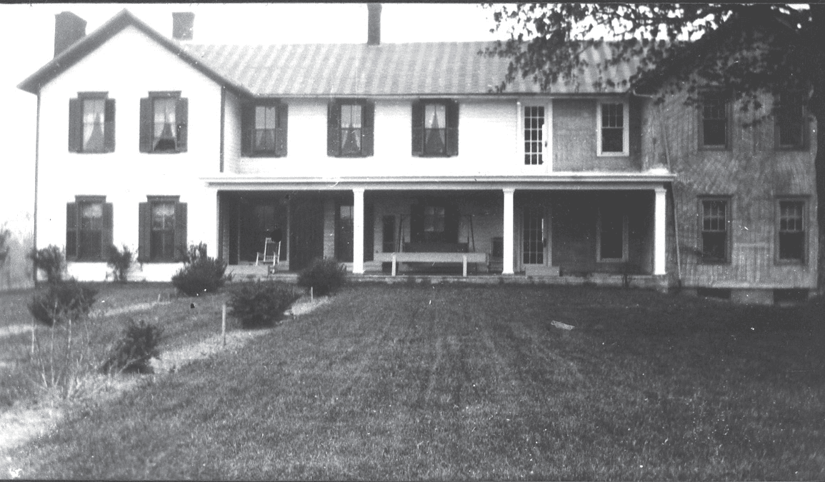 An Old Black and White Photo of a Large House